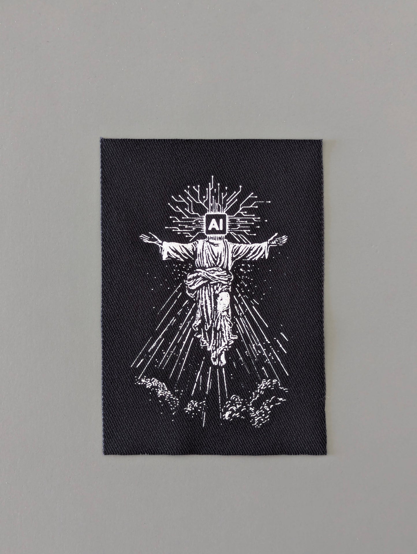 Black patch with white illustration of a prophet with 'AI' on its head, symbolizing humanity will depend on Artificial Intelligence 